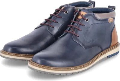 A pair of blue leather chukka boots with brown laces and tan accents, displayed on a white background.