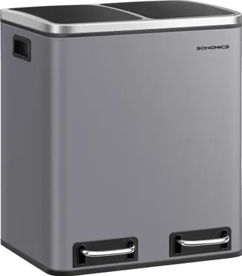 A gray dual-compartment trash can with silver pedals.