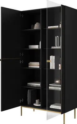 A black cabinet with glass doors and gold legs, displaying books and decorative items on its shelves.