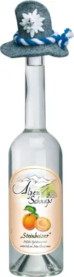 A bottle of Alpenschnaps Steinbeisser Marille Likör with a decorative hat on top.