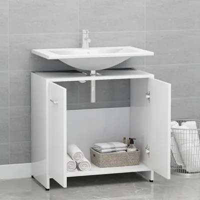 A white bathroom vanity with a sink and faucet is shown in a bathroom with gray tiled walls.