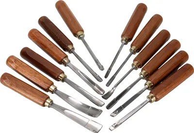 A collection of wood carving chisels arranged on a white background.