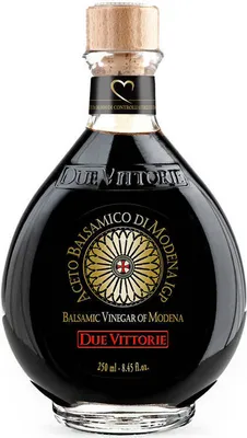 A bottle of balsamic vinegar on a white background.
