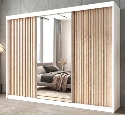 A bedroom scene with a large wardrobe featuring mirrored doors and slatted wooden panels.