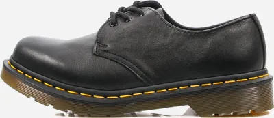 A side view of a black Dr. Martens shoe.