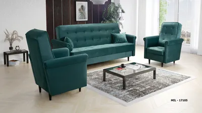 A teal living room furniture set including a sofa and two armchairs on a rug with a coffee table.