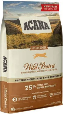 A bag of ACANA Wild Prairie cat food against a landscape background.