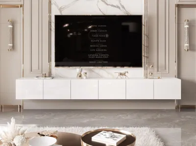 A modern living room with a large TV mounted above a white, high-gloss TV stand.