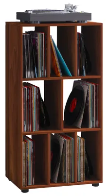 A record player sits on top of a wooden shelf unit filled with vinyl records.