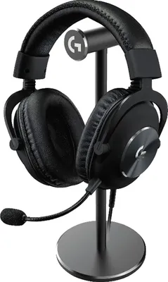 A black Logitech G PRO X gaming headset is displayed on a black stand against a white background.