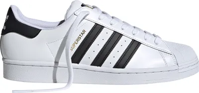 A side view of a white Adidas Superstar sneaker with black stripes.