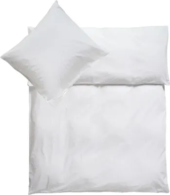 A white pillow and duvet cover are neatly folded on a white background.