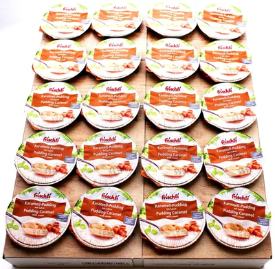 A collection of individual pudding cups arranged on a wooden surface.