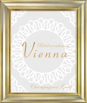 A gold picture frame with decorative elements and text.