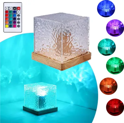 A cube-shaped lamp with a textured glass exterior and a wooden base, shown in various colors and projecting light patterns.