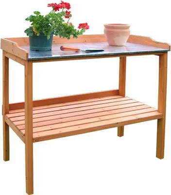 A wooden potting table with a galvanized work surface, a potted plant, and a terracotta pot.