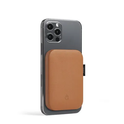 A smartphone with a brown magnetic power bank attached to its back.
