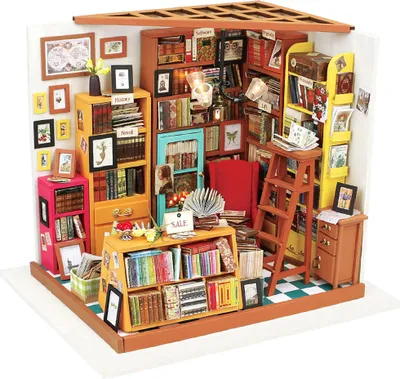 A miniature diorama of a library with shelves filled with books, a chair, and a ladder.