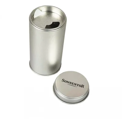 A silver metal tin with its lid off, placed next to it on a white background.