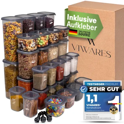 A collection of clear plastic food storage containers filled with various food items, arranged in front of a cardboard box with branding and promotional text.