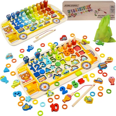 Two identical wooden sorting and counting toys shaped like buses are displayed side-by-side on a white background. The toys are filled with colorful wooden pieces, including numbers, shapes, and small vehicle figures. A green drawstring bag and a cardboard