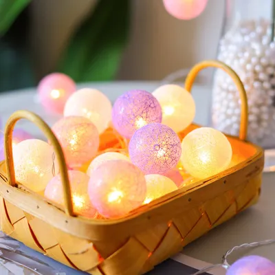 A basket filled with colorful, glowing LED ball lights.