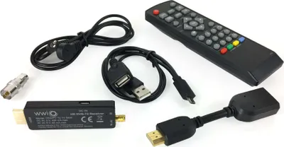 A collection of electronic accessories, including a TV receiver stick, remote control, cables, and adapters, laid out on a white background.