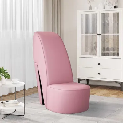 A pink high-heeled shoe-shaped chair in a room with a white cabinet and a small round table.