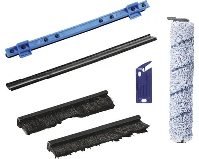 A collection of cleaning accessories for a Nilfisk machine, including brushes, a squeegee blade, and a roller brush, arranged on a white background.