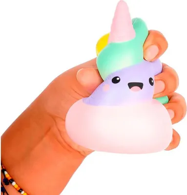 A hand is squeezing a squishy toy shaped like a unicorn.