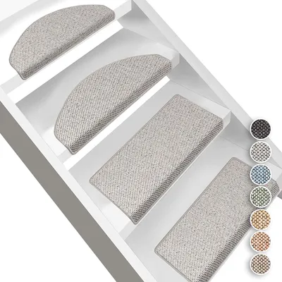 Stair mats are placed on stairs in a white staircase.