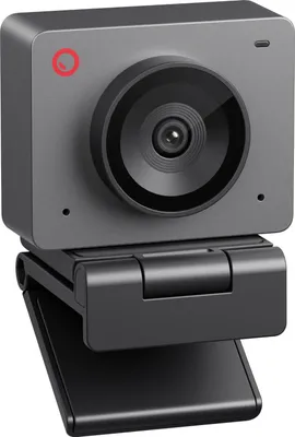 A close-up studio shot of a gray webcam with a black lens and a black adjustable stand.