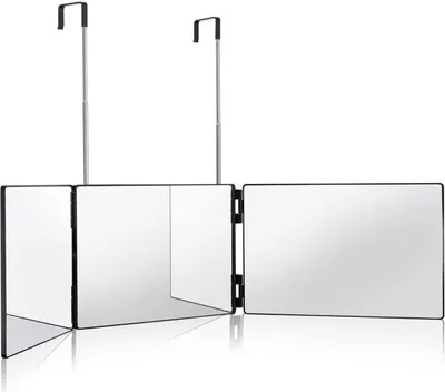 A tri-fold mirror with hanging hooks against a white background.