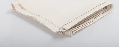A folded piece of white fabric is shown on a white background.