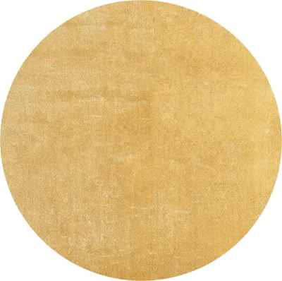 A circular rug with a textured, golden-brown surface.