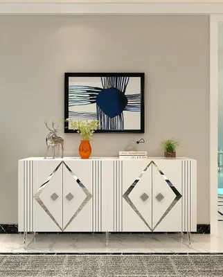 A white sideboard with silver diamond accents and decorative elements on top, displayed in a room.