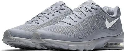 A pair of gray Nike Air Max Invigor shoes are shown against a white background.