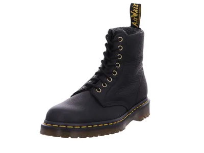 A black Dr. Martens boot on a white background.