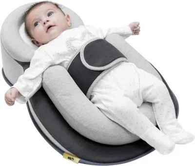 A baby lying in a specialized sleeping aid.