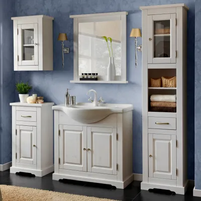 A bathroom vanity set with a sink, mirror, and storage cabinets against a blue wall.