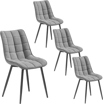 Four grey upholstered dining chairs with black metal legs are arranged on a white background.