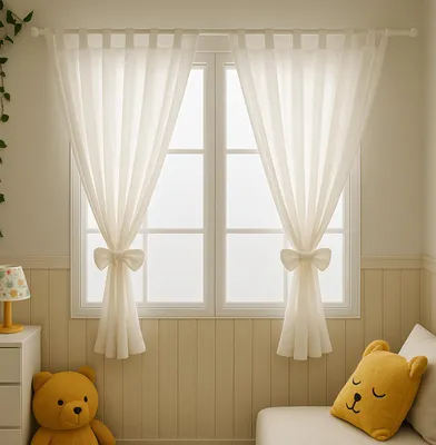 A bedroom scene with curtains, a teddy bear, and a pillow.