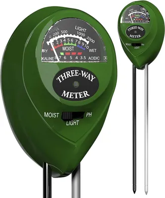 A close-up of a green three-way soil tester with a dial and a switch.