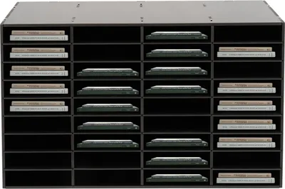 A dark gray shelving unit with multiple compartments, some filled with books and what appear to be electronic devices or cases.