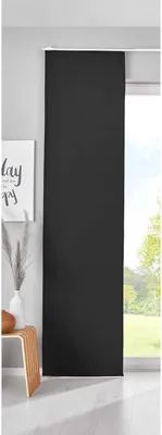 A black sliding curtain panel is shown hanging in front of a window, with a glimpse of greenery outside. A small wooden stool and a vase with dried grass are visible to the left.