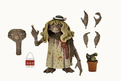A collection of E.T. action figure accessories and a figure dressed as a woman, laid out on a white background.