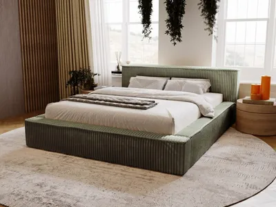 A bedroom scene with a bed as the main focus, decorated with plants and natural light.