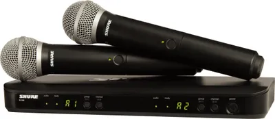 Two black wireless microphones are placed on top of a black receiver unit.