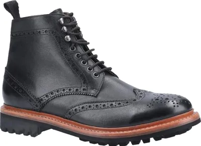 A black leather boot with brogue detailing and laces.