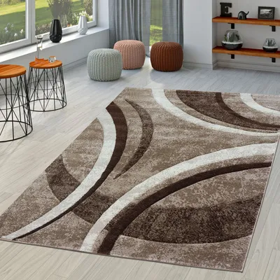 A living room scene with a rug, side tables, and poufs.